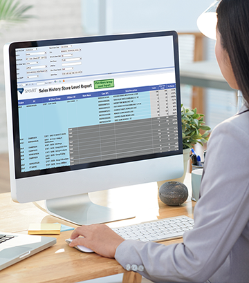 Women with hand on keyboard looking at computer screen. Screen has SMARdock spreadsheet